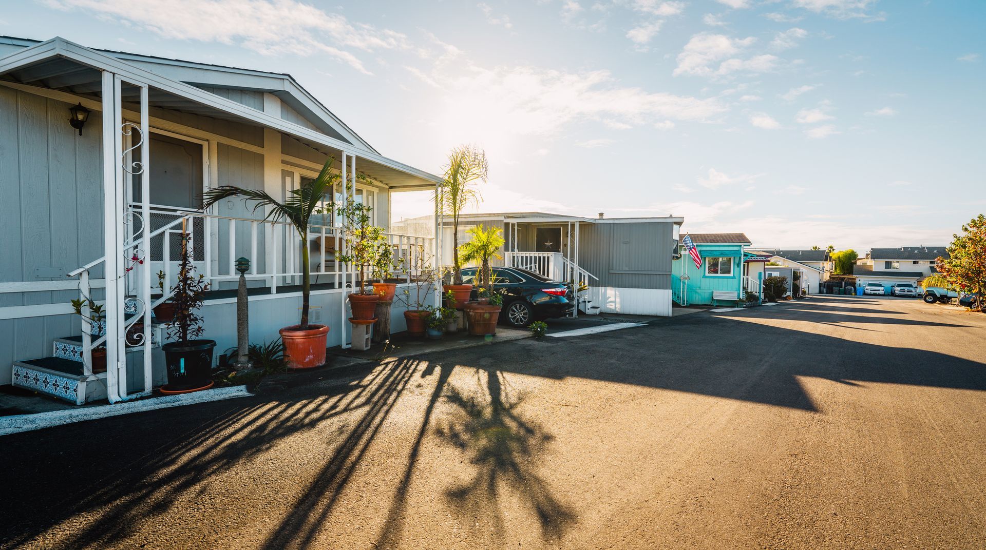 A row of rvs are parked in a parking lot.